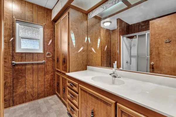 a bathroom with a shower and a sink