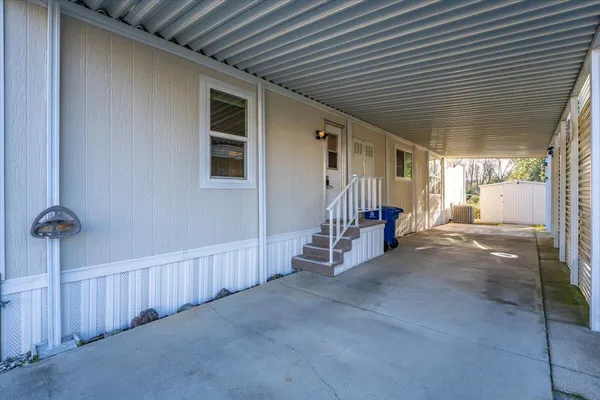 a view of a house with a backyard and wooden fence