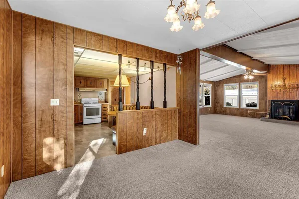 a view of a hallway with furniture and a livingroom