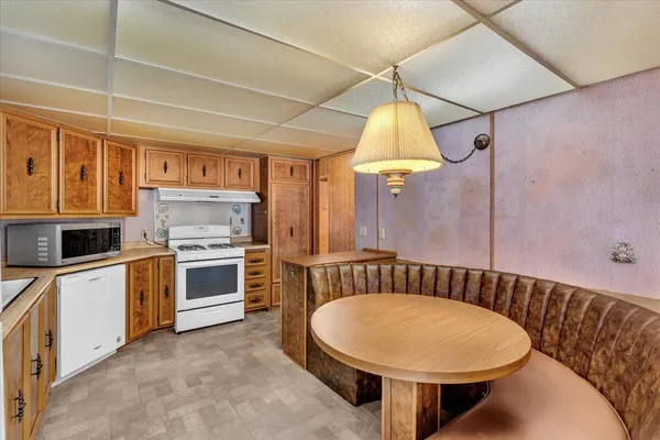 a kitchen with a stove a sink and a refrigerator