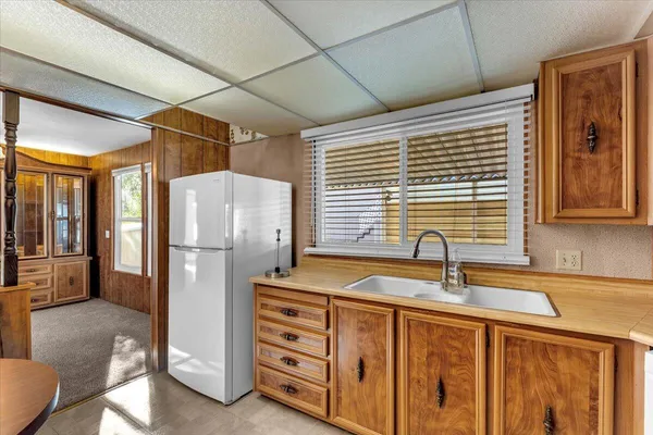 a kitchen with stainless steel appliances granite countertop a refrigerator and a sink