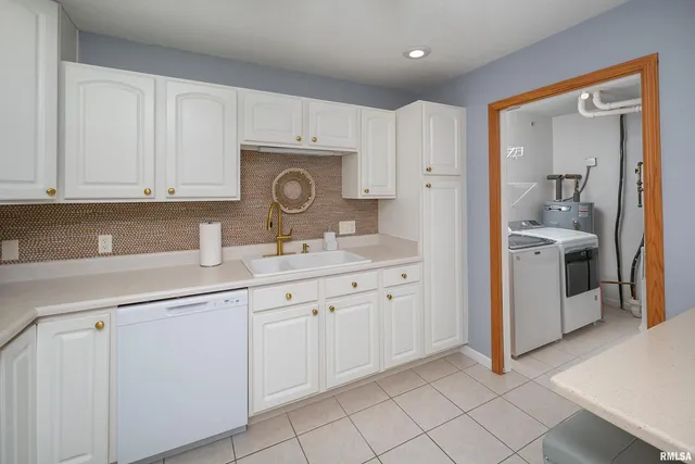 a kitchen with kitchen island a white cabinets and refrigerator
