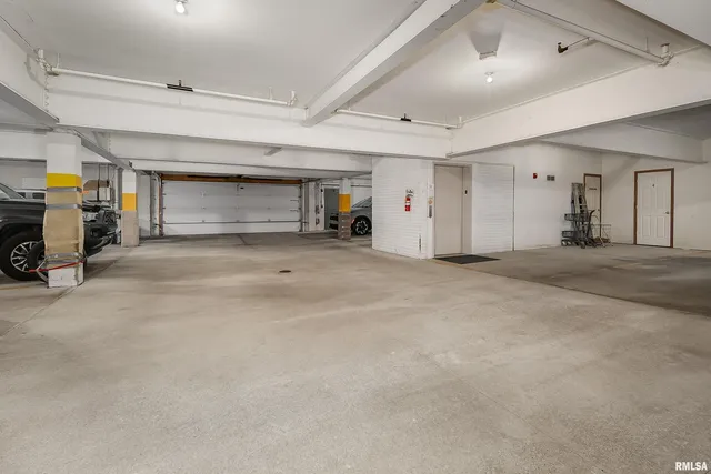 a front view of a house with a yard and potted plants