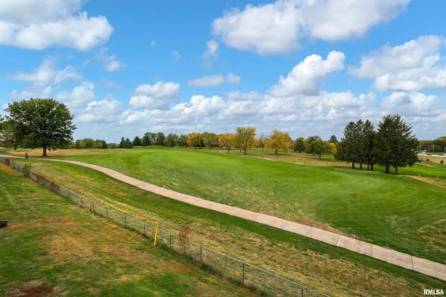 a living room with furniture a fireplace and flat screen tv