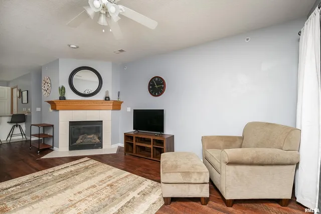 a living room with furniture and view of kitchen