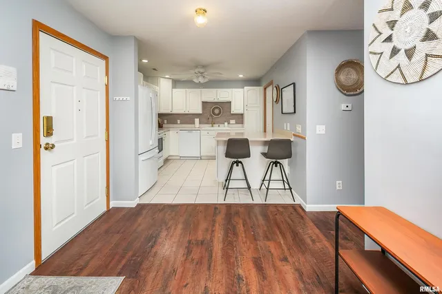 a kitchen with stainless steel appliances a stove a sink cabinets and a refrigerator