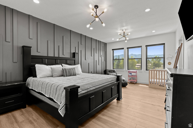3111 South 1250 West Logan, UT 84321 - Photo 15 of 51 Spacious room featuring a textured accent wall, light wood-finish flooring, and multiple windows