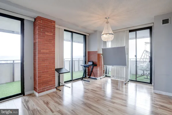 a view of a livingroom with furniture wooden floor and windows