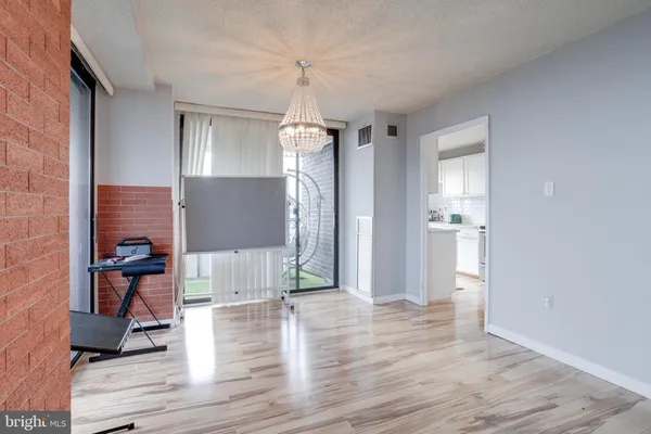 a view of a livingroom with wooden floor and a ceiling fan