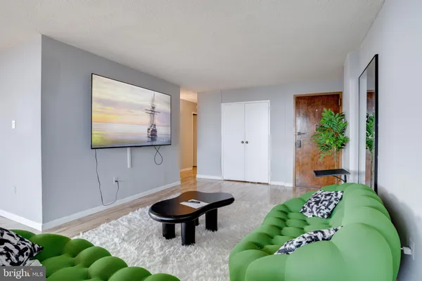 a living room with furniture and a potted plant