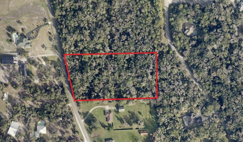 South Glencoe Road New Smyrna Beach, FL 32168 - Photo 3 of 4 a view of entryway with flower plant