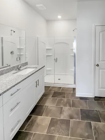 a kitchen with stainless steel appliances a refrigerator sink and white cabinets
