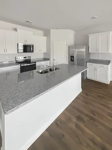 a view of kitchen with wooden floor
