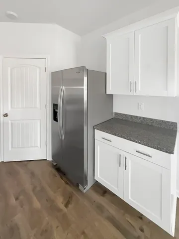 a large white kitchen with cabinets