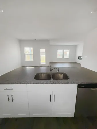 a kitchen with stainless steel appliances white cabinets and a granite counter tops