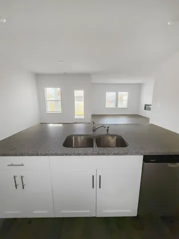 a kitchen with stainless steel appliances white cabinets and a granite counter tops