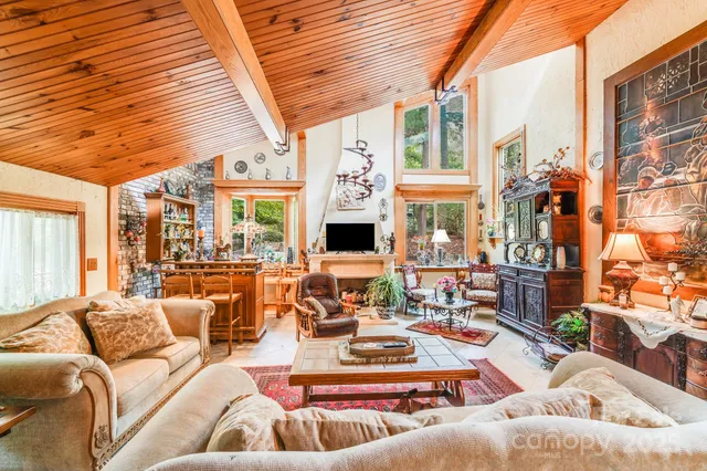 a living room with furniture fireplace and a large window