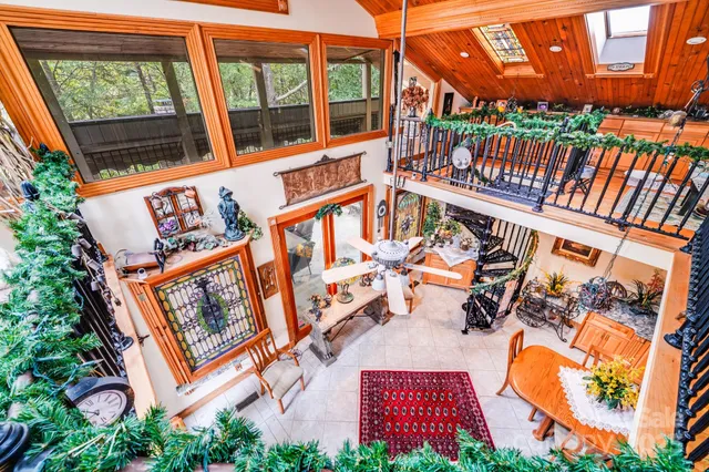 a view of a dining room with furniture and chandelier fan