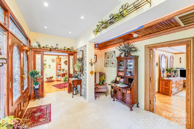 a very nice looking room with many windows and furniture