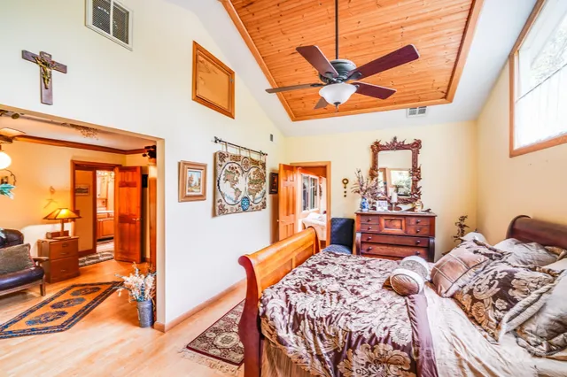a bed sitting in a bedroom next to a window