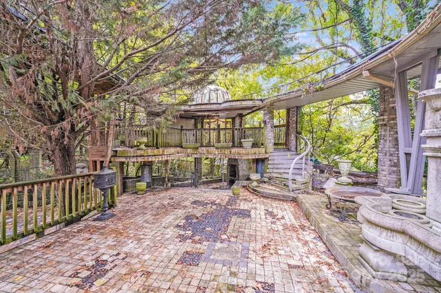 a room with lots of tables a large window and chairs