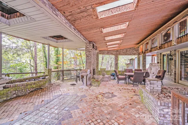 a sidewalk with a tree in front of it