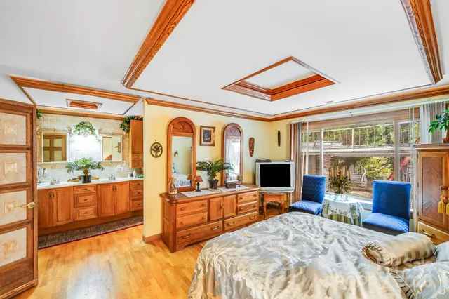 a bedroom with furniture and large windows
