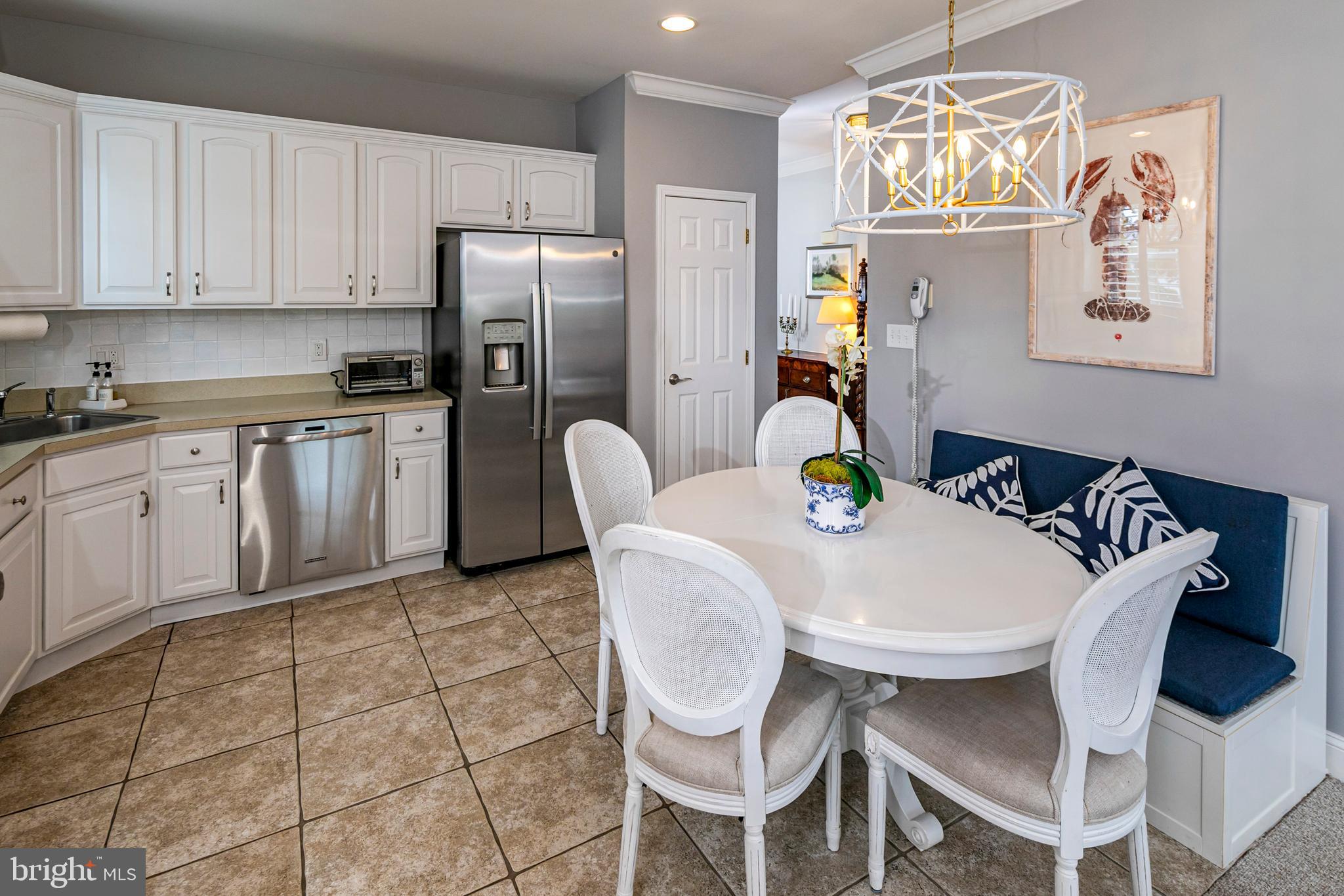 24 Foster Road Pennington, NJ 08534 - Photo 14 of 38 a kitchen with stainless steel appliances granite countertop a dining table chairs and a refrigerator
