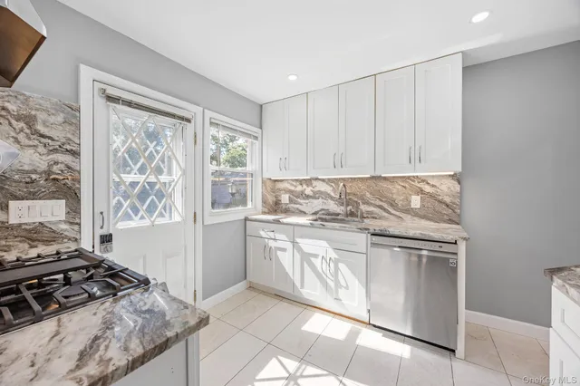a kitchen with stainless steel appliances granite countertop a stove and a refrigerator