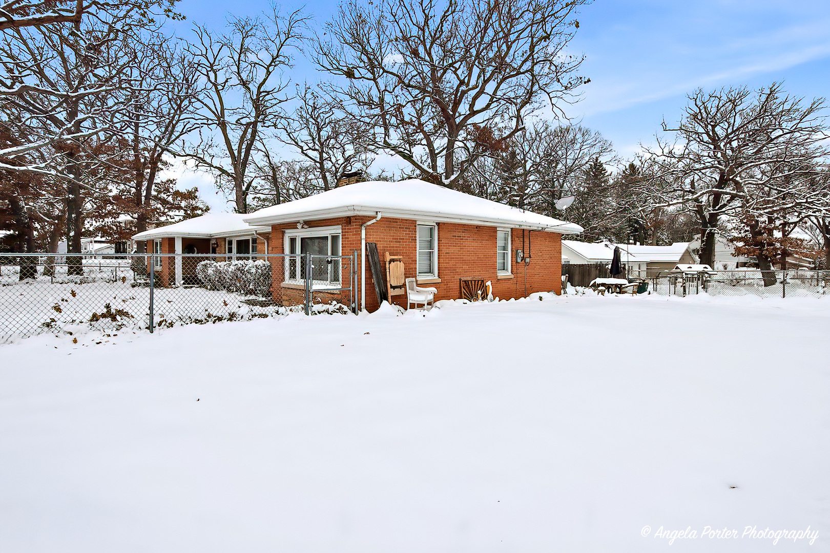50 East Oak Street Fox Lake, IL 60020 - Photo 12 of 16 a front view of a house with a yard covered with snow
