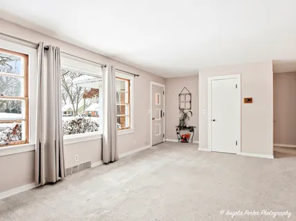 an empty room with closet and mirror