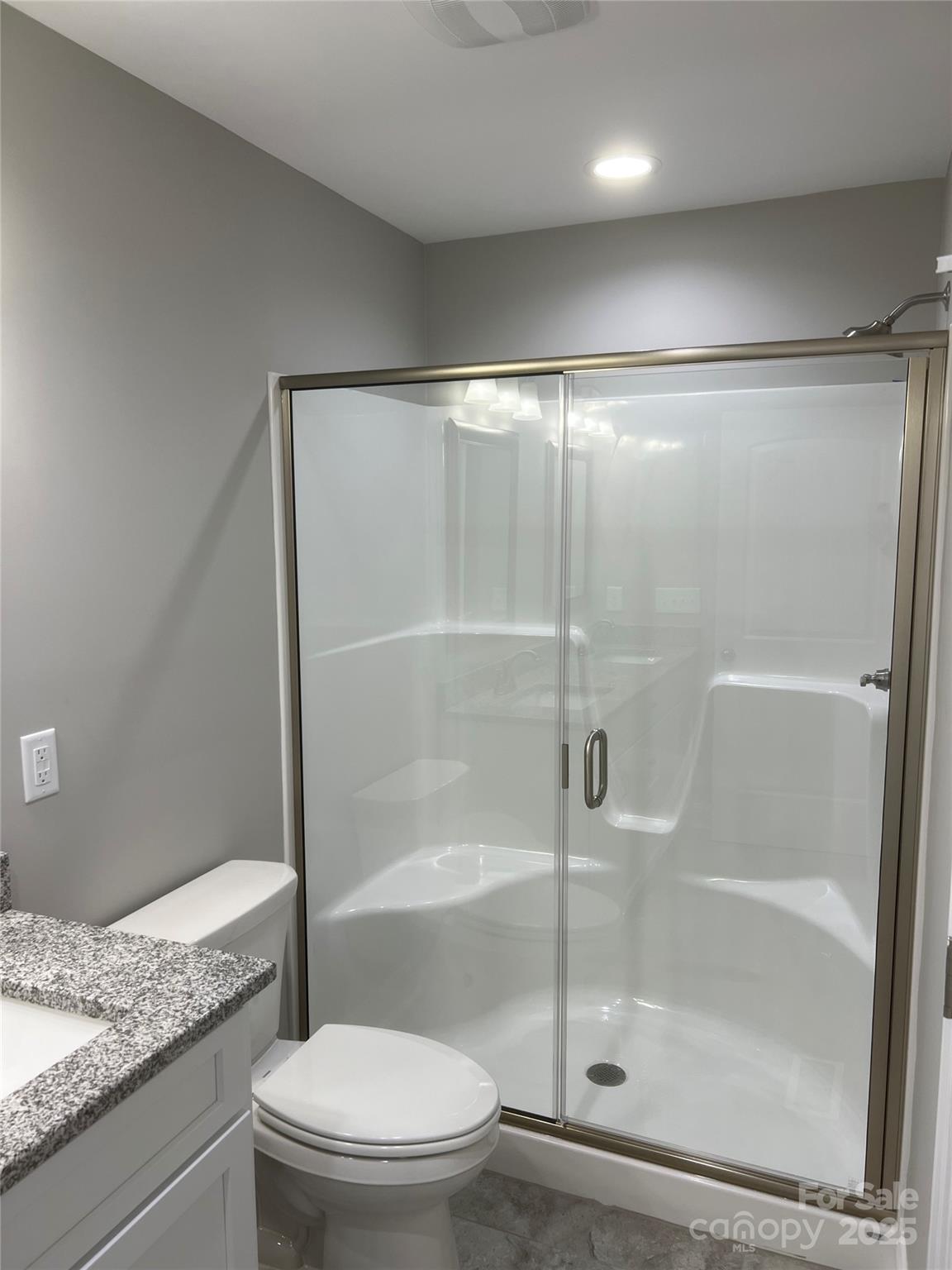 302 East Boyd Street, Unit B Maiden, NC 28650 - Photo 11 of 12 a bathroom with a granite countertop bathtub shower and toilet