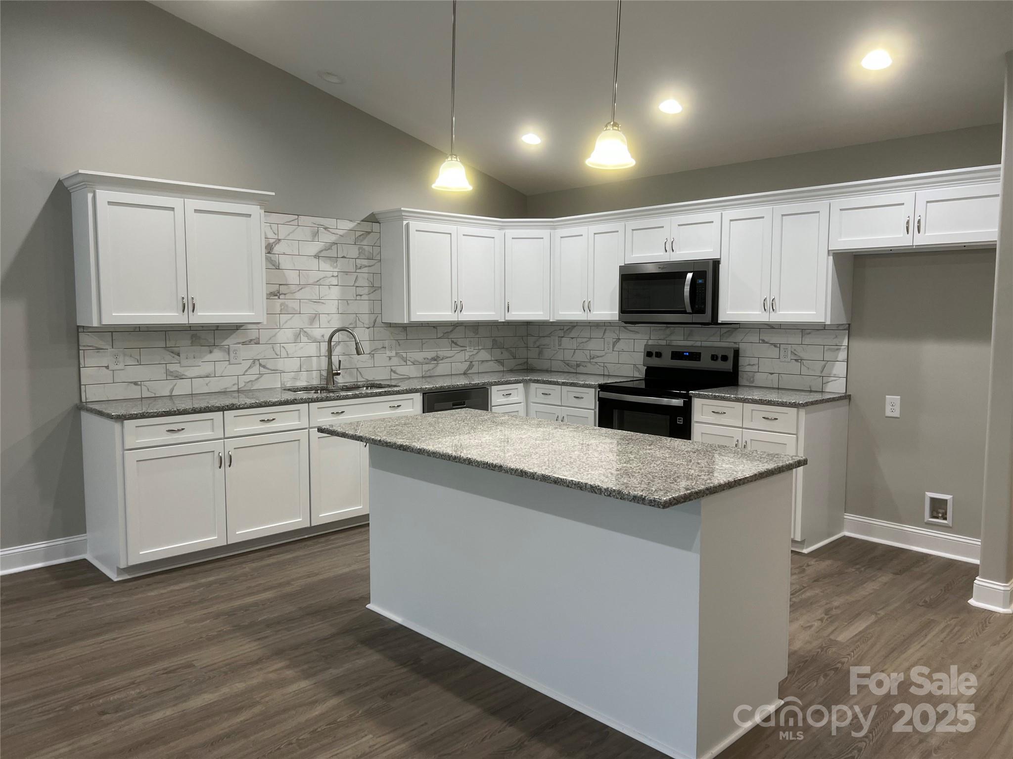 302 East Boyd Street, Unit B Maiden, NC 28650 - Photo 3 of 12 a kitchen with stainless steel appliances granite countertop a sink a stove a microwave a refrigerator a white cabinets and wooden floor
