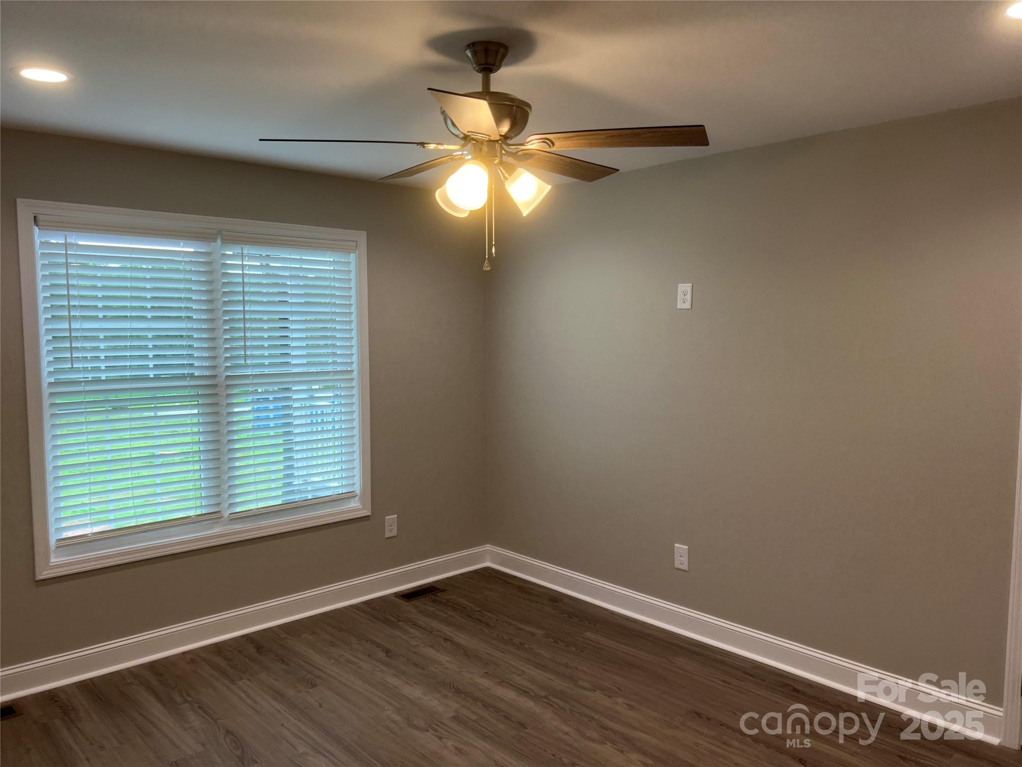 302 East Boyd Street, Unit B Maiden, NC 28650 - Photo 5 of 12 a view of an empty room with wooden floor and a window