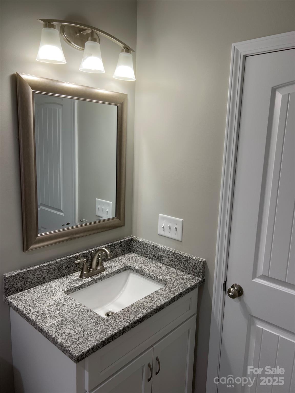 302 East Boyd Street, Unit B Maiden, NC 28650 - Photo 6 of 12 a bathroom with a granite countertop sink and a mirror