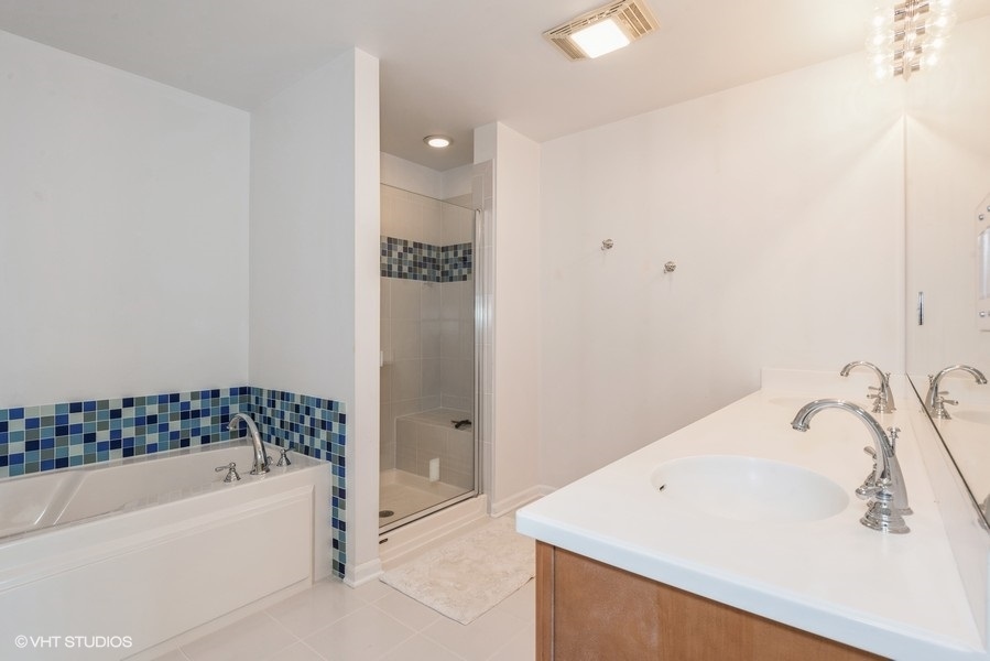 1228 Emerson Street, Unit 304 Evanston, IL 60201 - Photo 9 of 19 a bathroom with a bathtub and shower