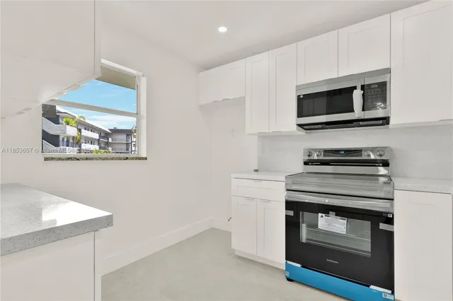 a kitchen with a stove and a microwave