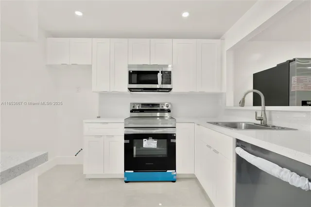 a kitchen with granite countertop a stove and a sink