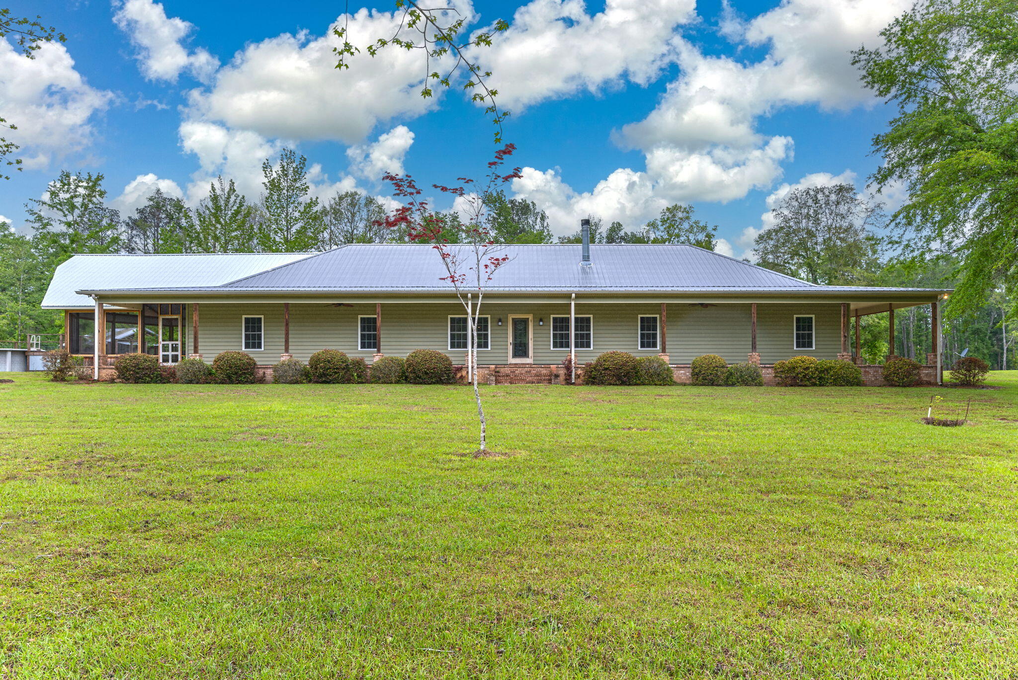 a front view of a house with a garden