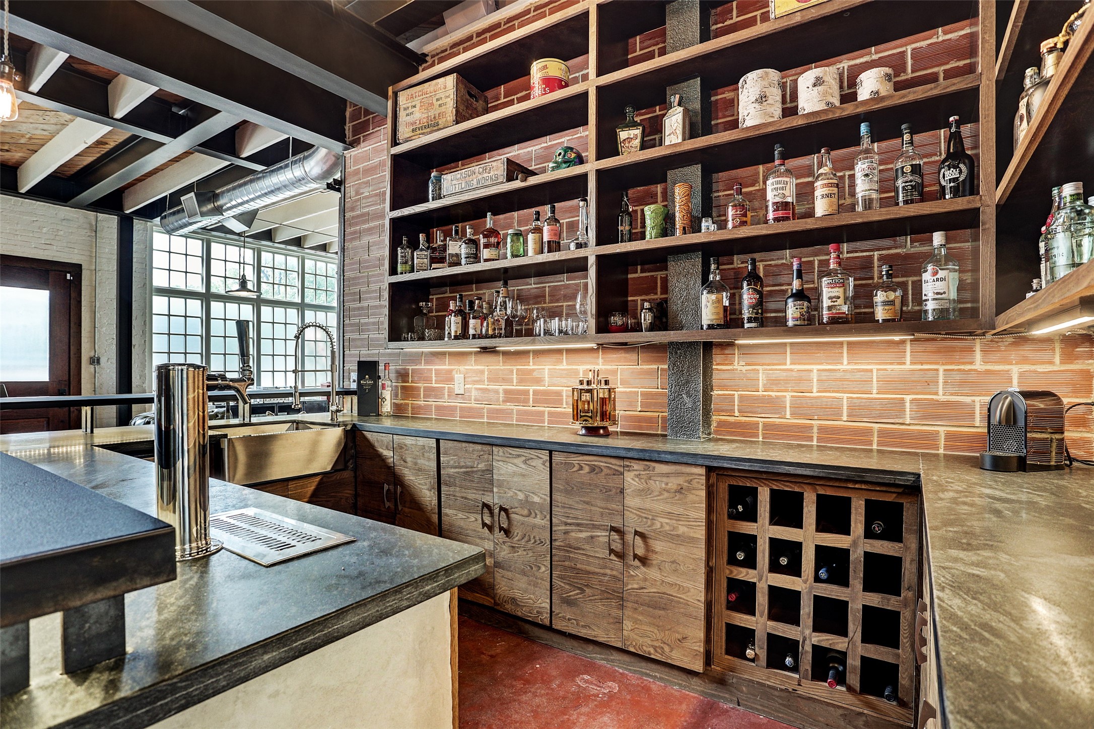 808 Coronado Street Houston, TX 77009 - Photo 11 of 50 Unit 1, view from inside the wet bar equipped with a beverage fridge, dishwasher, farmhouse sink, open shelving, and brick backsplash beneath the floating staircase.