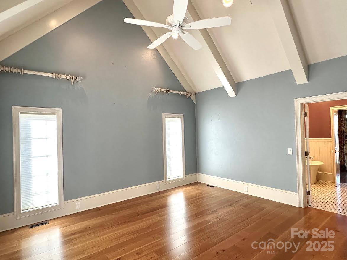 520 East Landing Ridge Circle Jefferson, NC 28640 - Photo 15 of 48 an empty room with wooden floor fan and windows