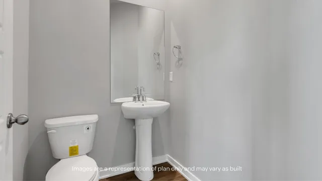 a bathroom with a sink a toilet and mirror