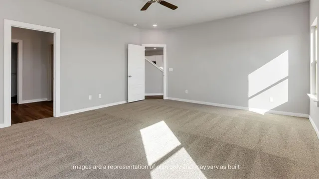 an empty room with windows and chandelier fan
