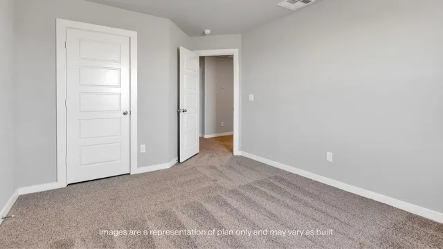a view of an empty room with closet area