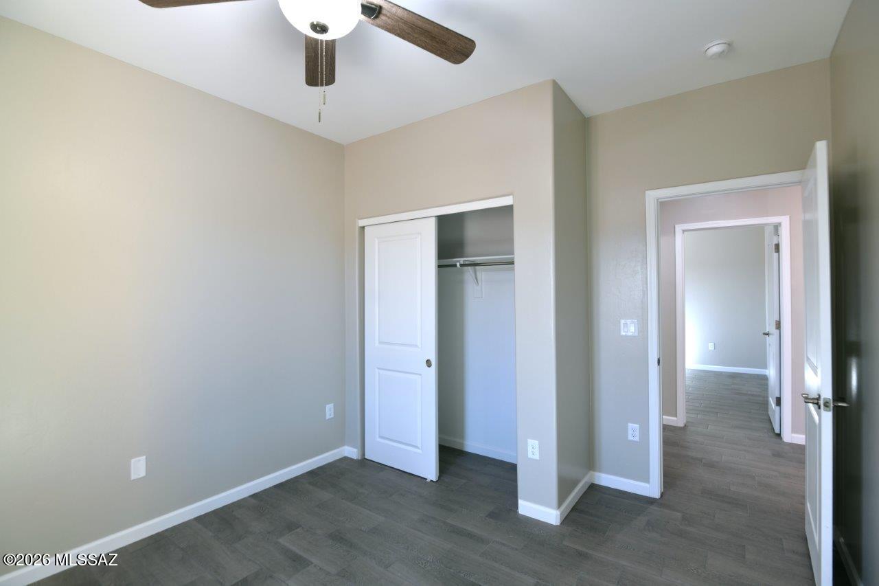 1091 North Vail View Road Vail, AZ 85641 - Photo 31 of 43 wooden floor in an empty room with a window