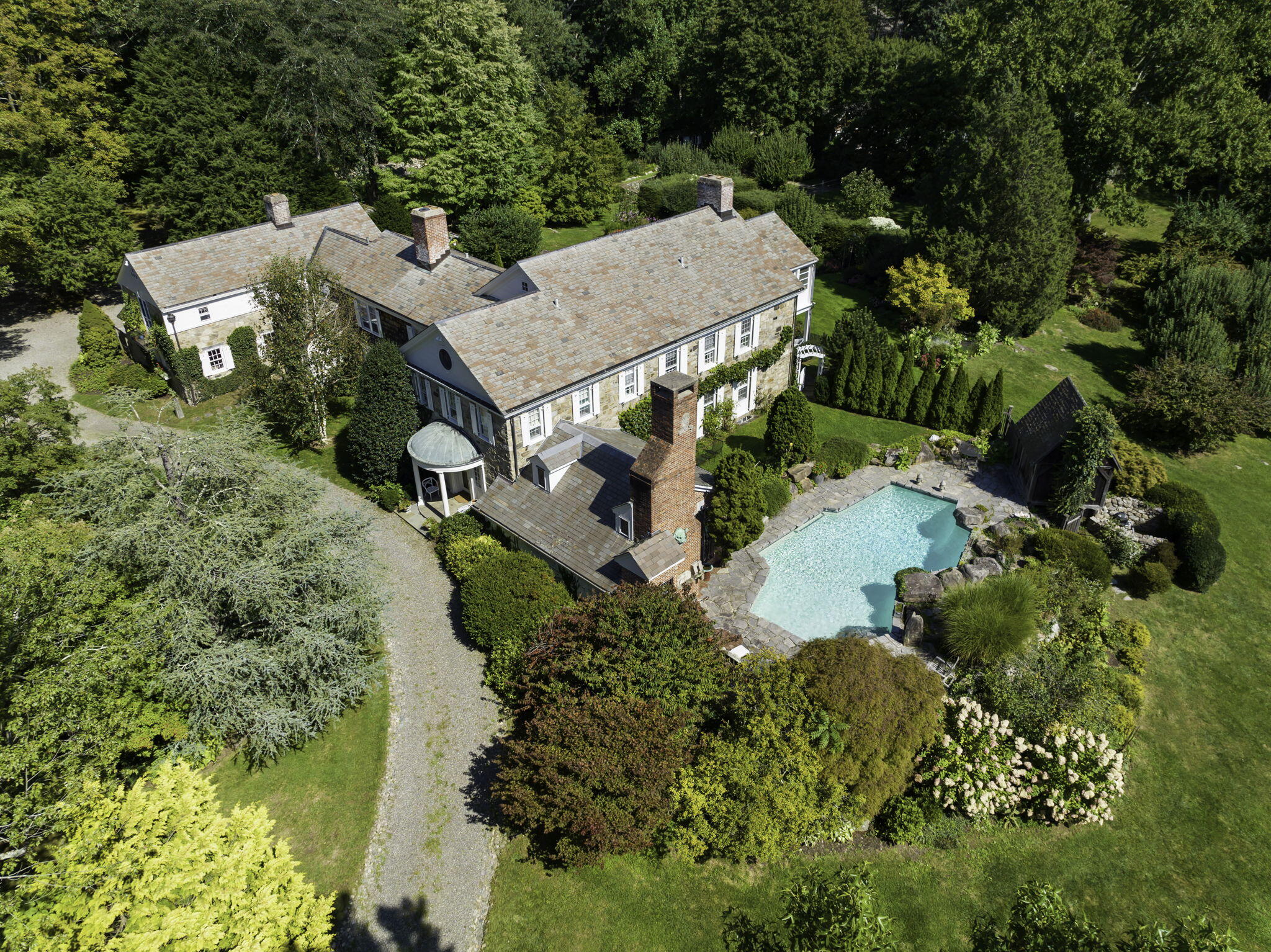 an aerial view of a house with a yard and lake view