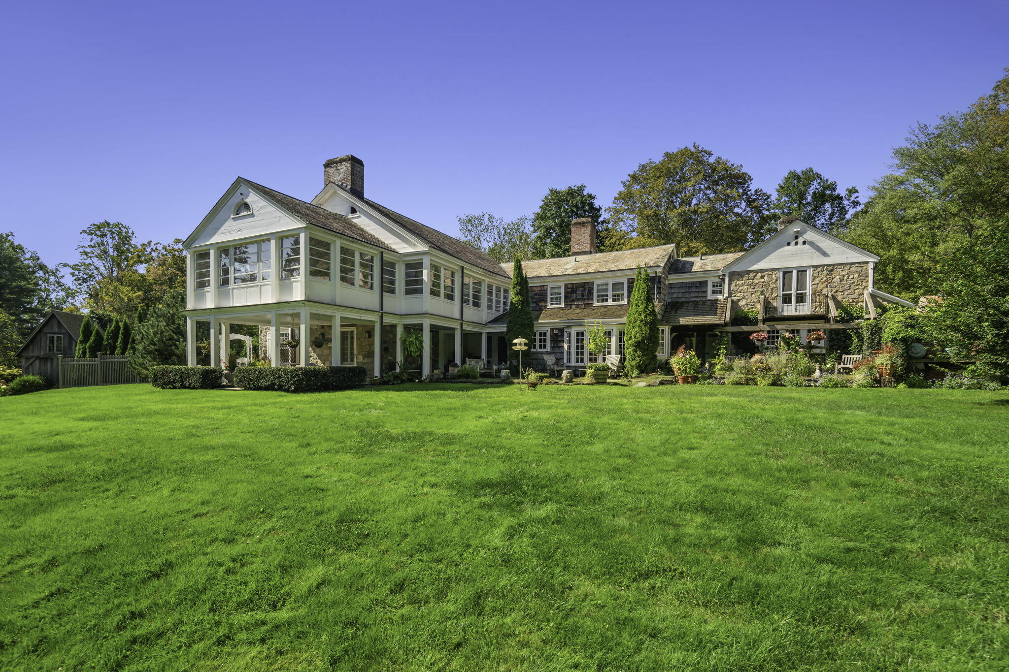 301 Michigan Road New Canaan, CT 06840 - Photo 4 of 46 a front view of a house with a yard and trees
