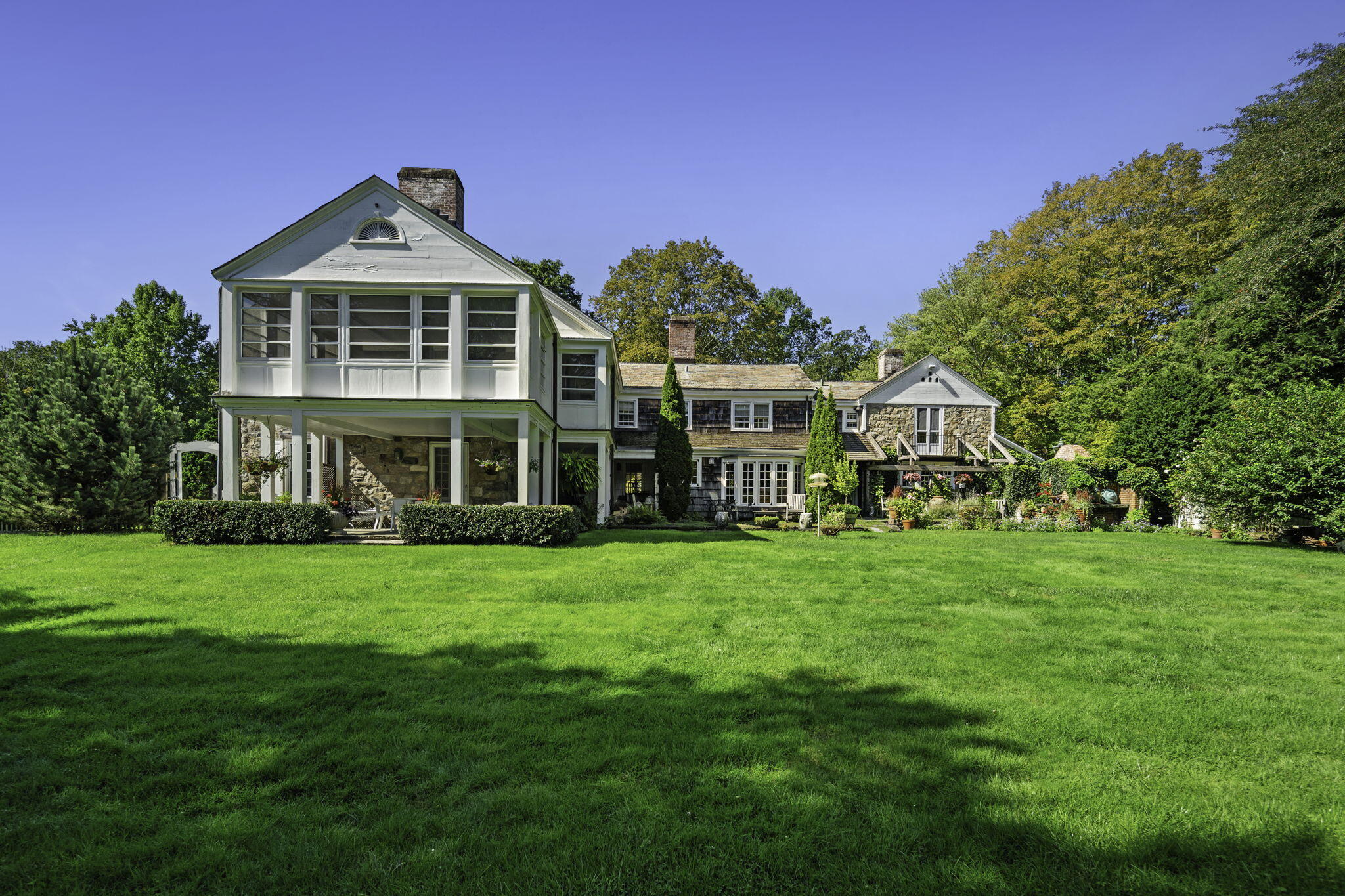 301 Michigan Road New Canaan, CT 06840 - Photo 5 of 46 a front view of a house with a yard