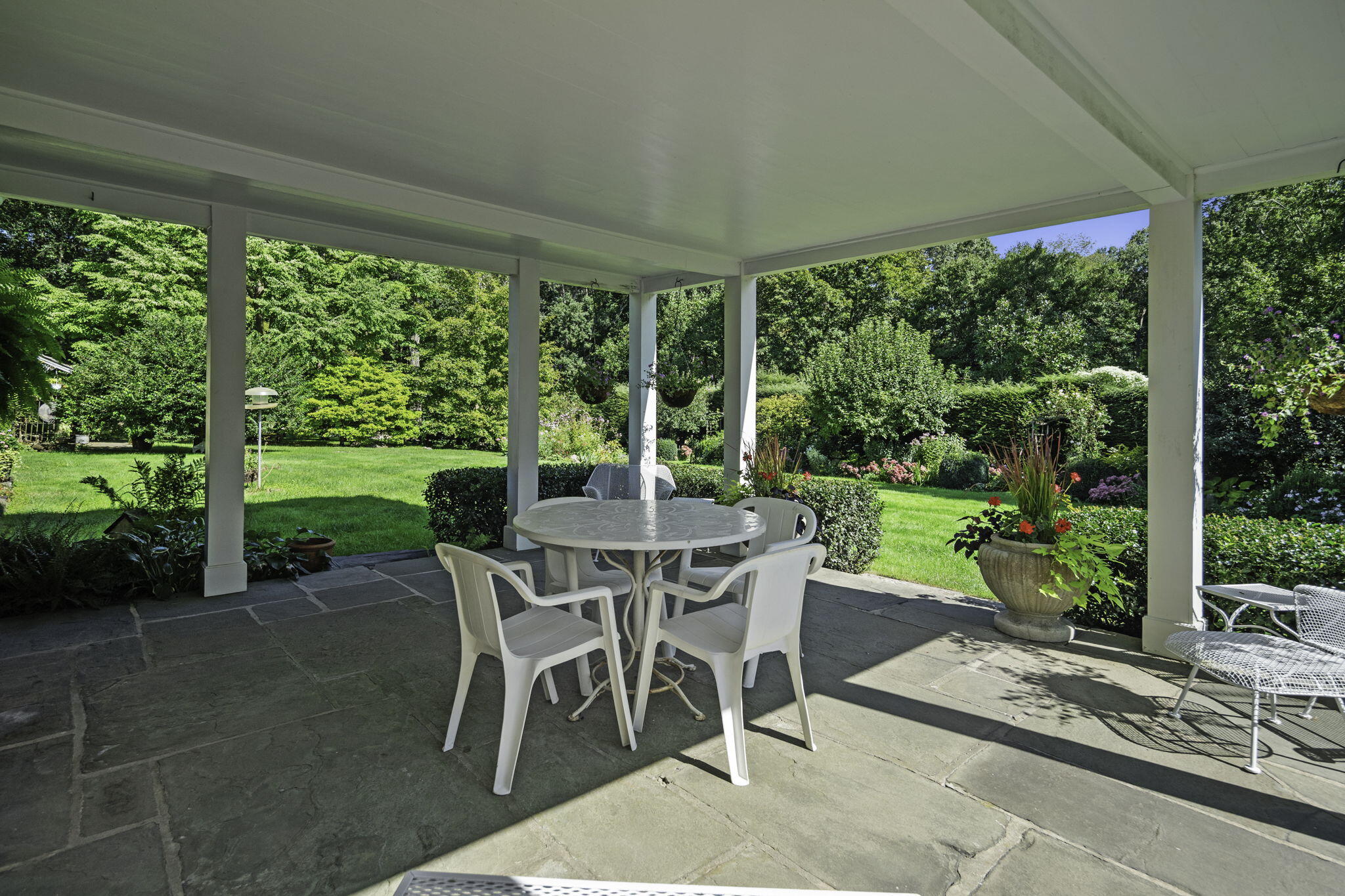 301 Michigan Road New Canaan, CT 06840 - Photo 7 of 46 a view of a patio with a backyard table and chairs