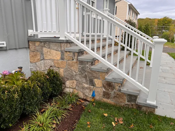 a view of building with yard and staircase